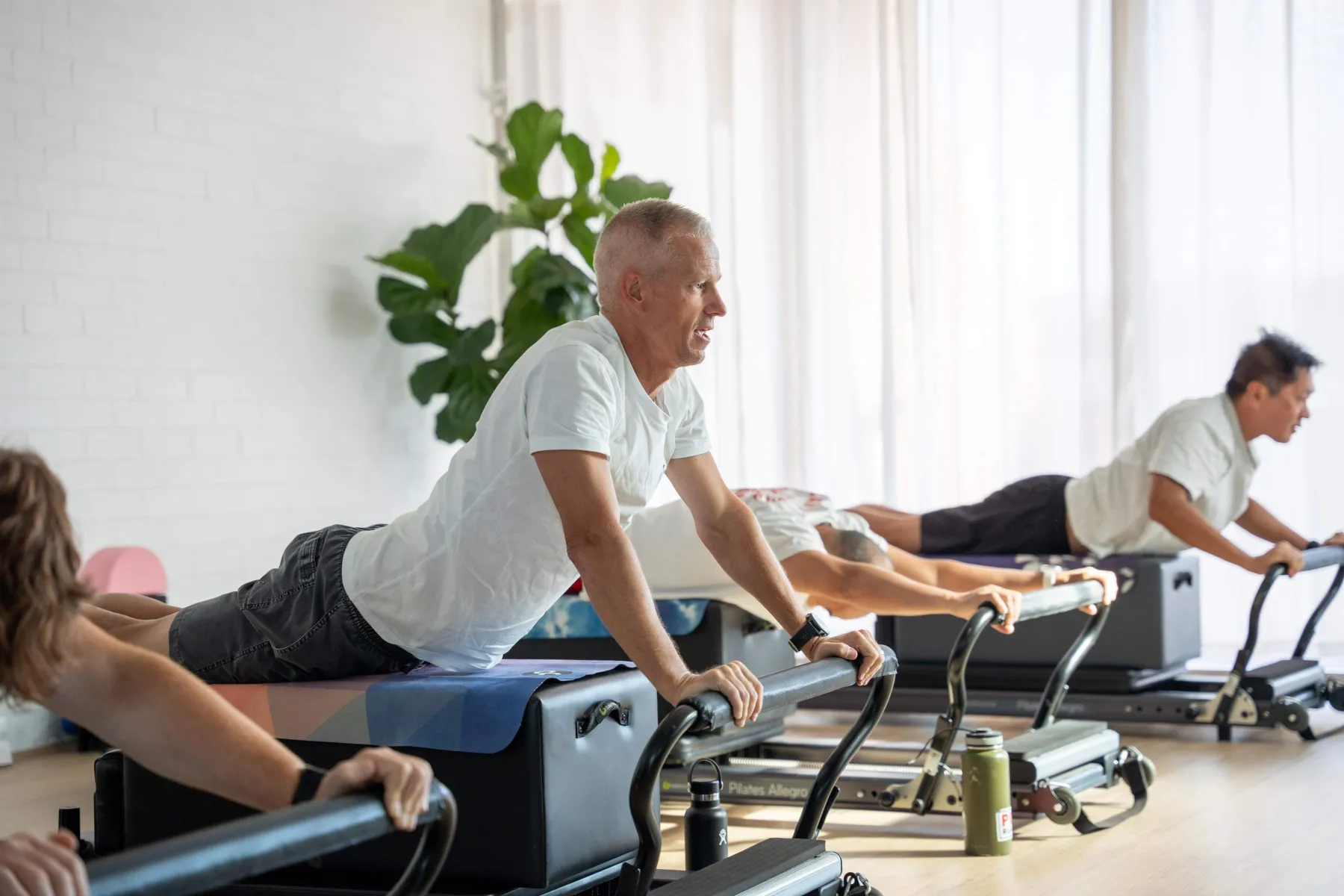 Men working on Reformers during a class at the Prack Pilates studio in Kiama